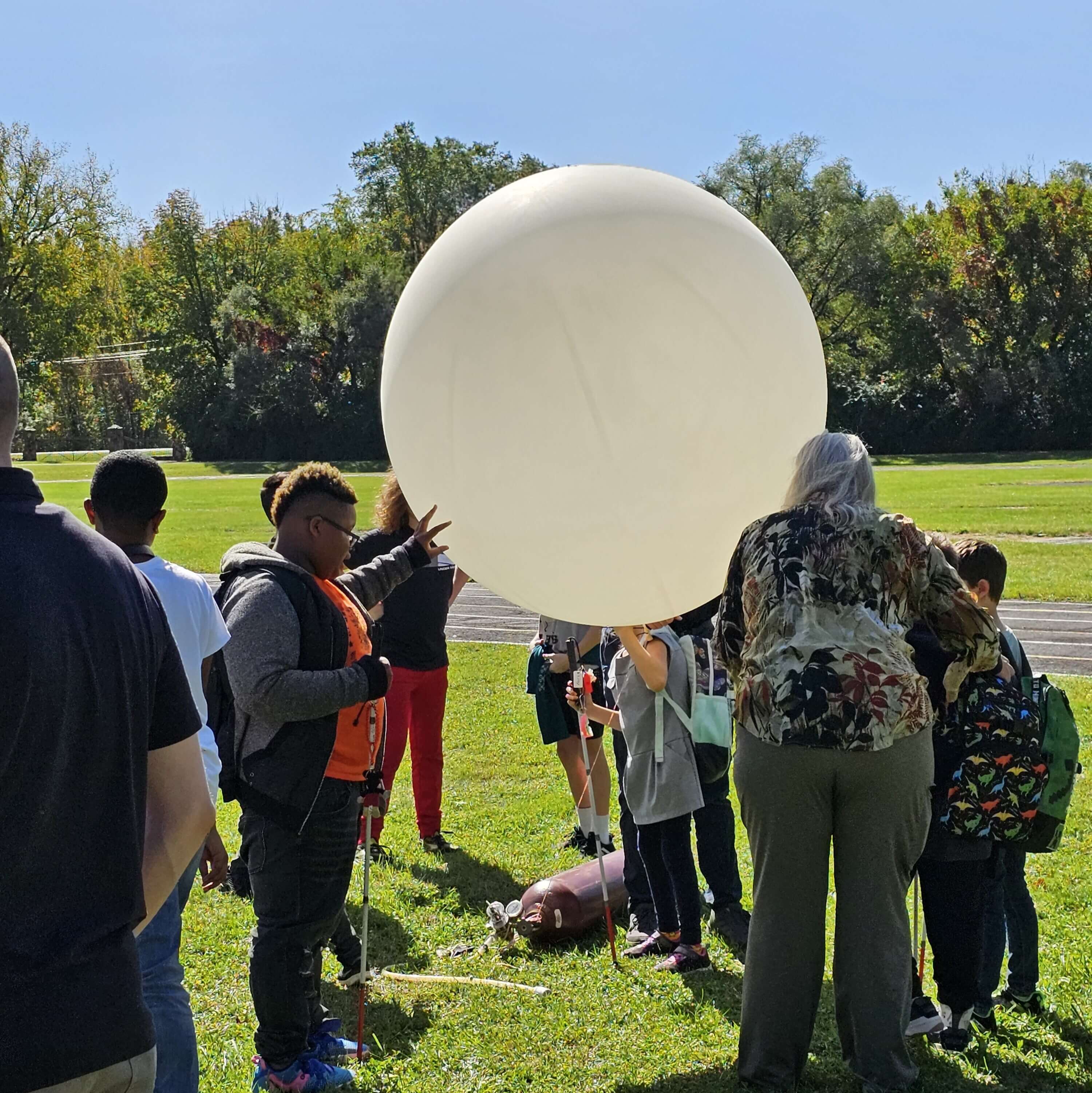 students launching a weather balloon